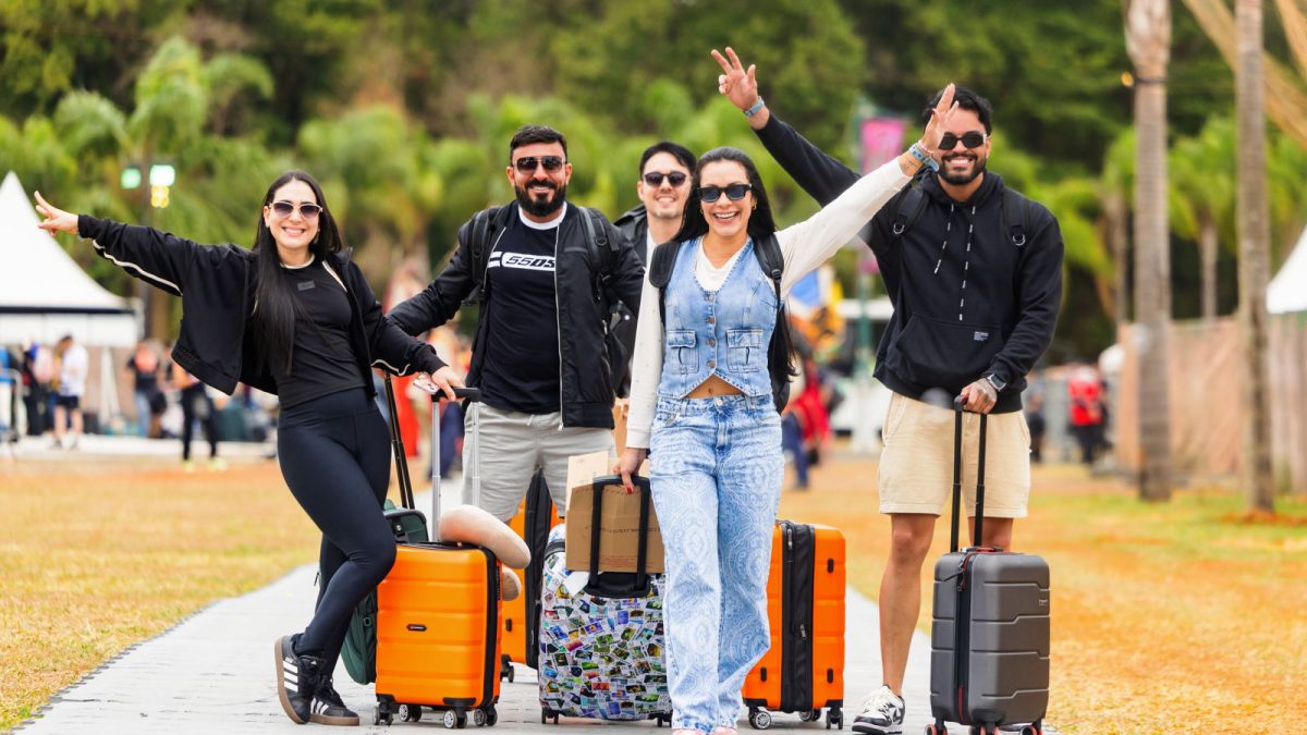 Grupo de amigos com mochilas e malas na chegada ao Dreamville do Tomorrowland Brasil.